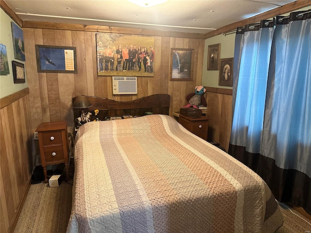 bedroom with carpet, wood walls, and an AC wall unit