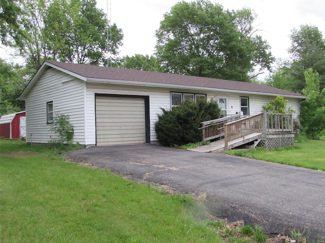 single story home with a wooden deck, a garage, and a front lawn