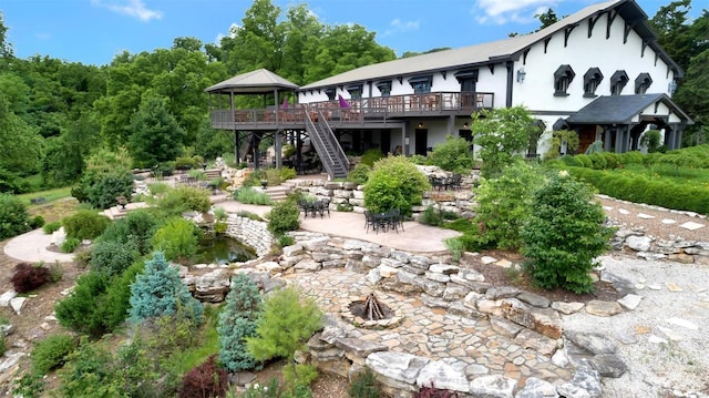 back of property with a patio area, a deck, and a gazebo