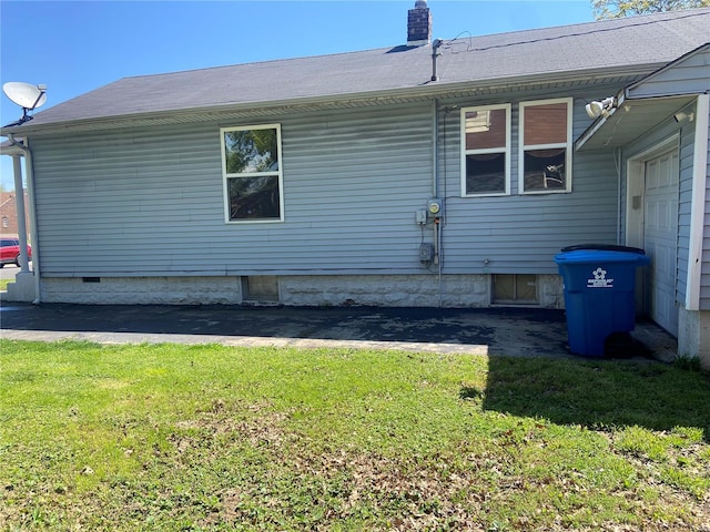 view of home's exterior with a garage and a yard