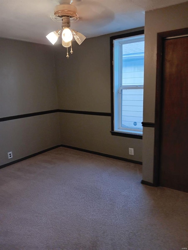 empty room featuring ceiling fan and carpet floors