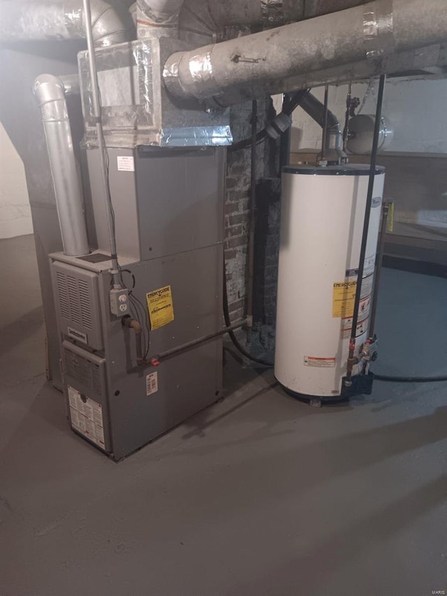 utility room featuring water heater and heating unit