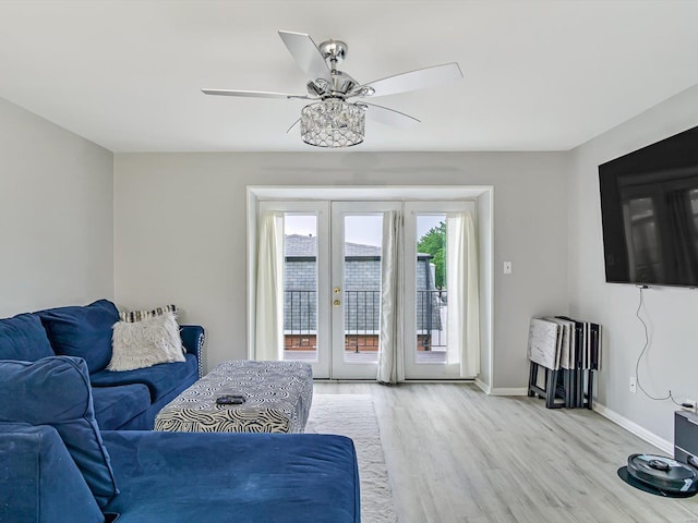 living room with ceiling fan, french doors, and light hardwood / wood-style flooring