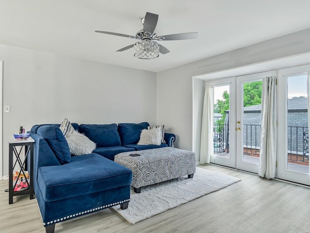 living room featuring ceiling fan, light hardwood / wood-style flooring, and french doors