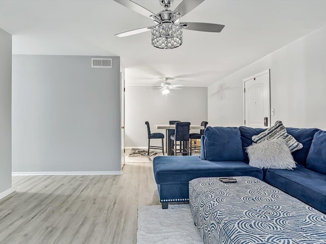 living room featuring hardwood / wood-style flooring and ceiling fan