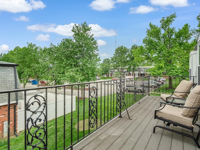 wooden terrace featuring a yard