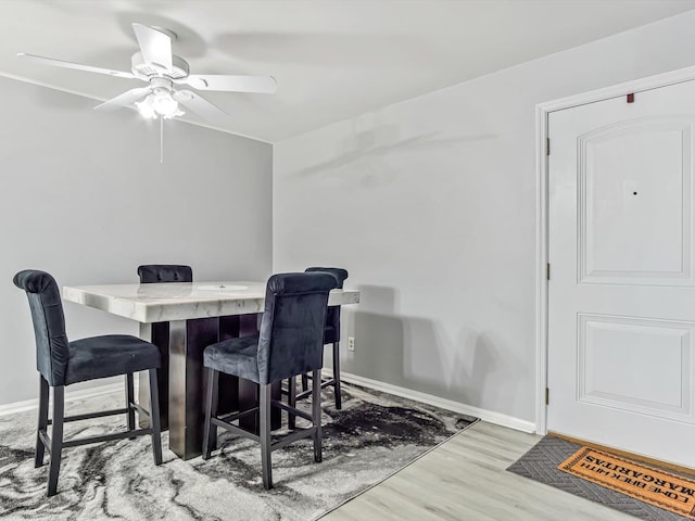 dining area with light hardwood / wood-style flooring and ceiling fan