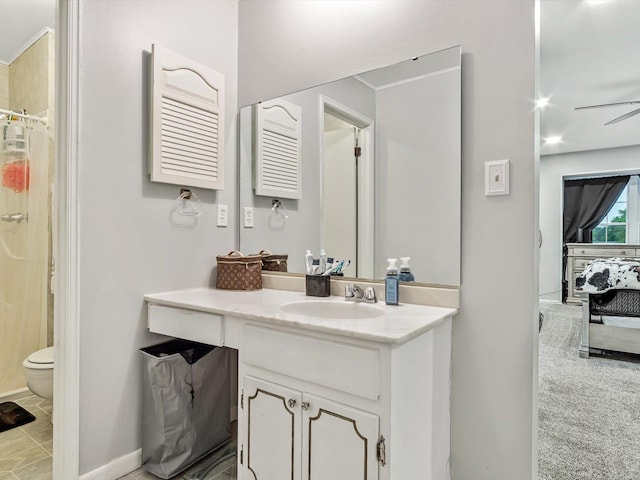 bathroom featuring vanity, tile patterned floors, ceiling fan, and toilet