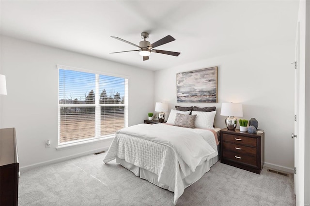 bedroom featuring light colored carpet and ceiling fan