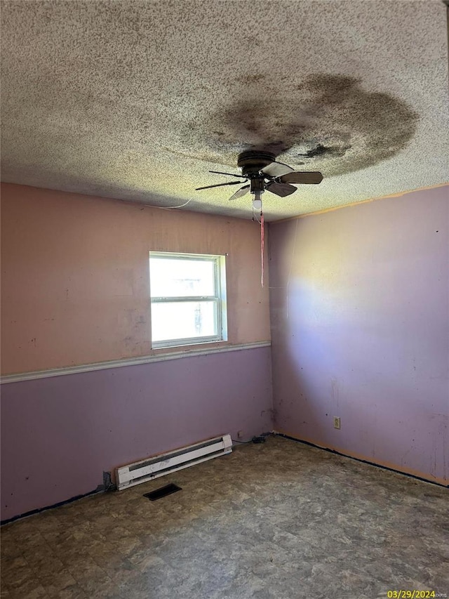 tiled spare room with a baseboard radiator, ceiling fan, and a textured ceiling