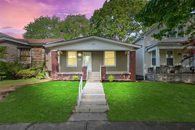 view of front of property with a yard and a porch