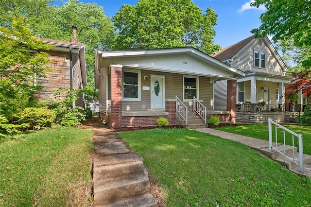 view of front of property with covered porch and a front lawn