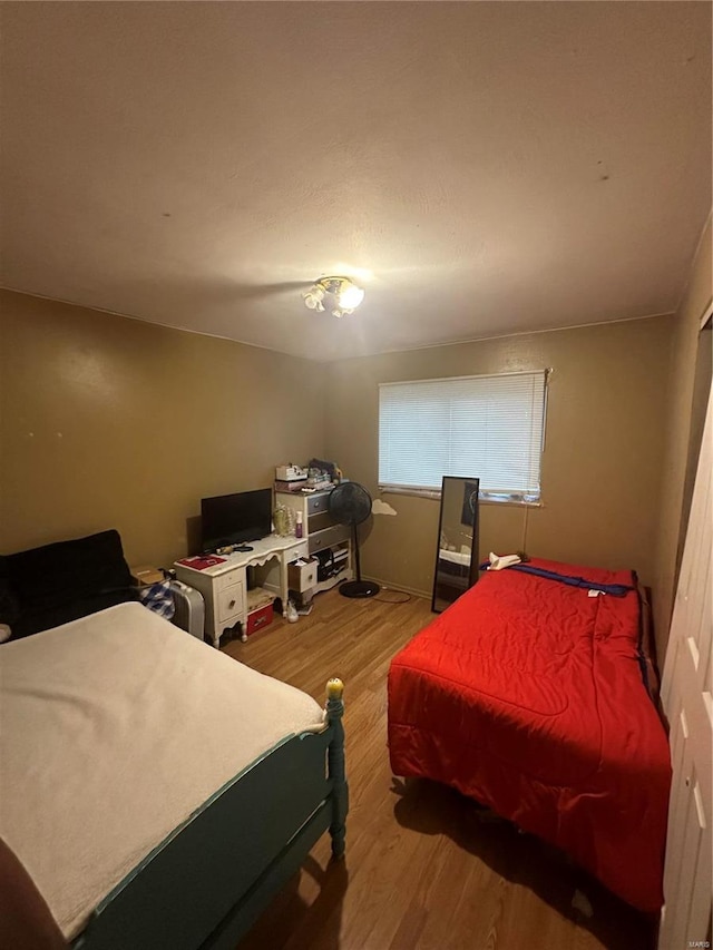 bedroom with hardwood / wood-style floors