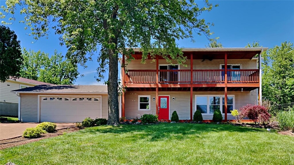 view of front of property with a garage and a front lawn