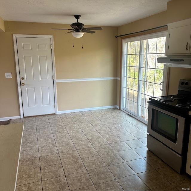 kitchen featuring range, ventilation hood, ceiling fan, light tile patterned floors, and white cabinetry