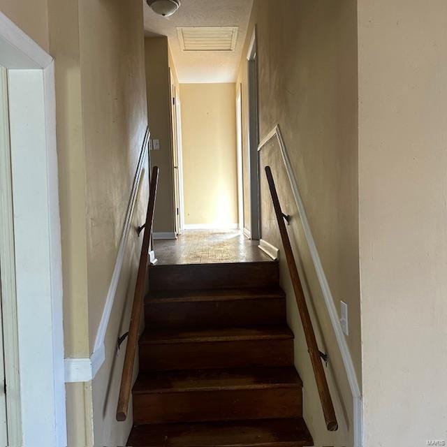 staircase with hardwood / wood-style flooring