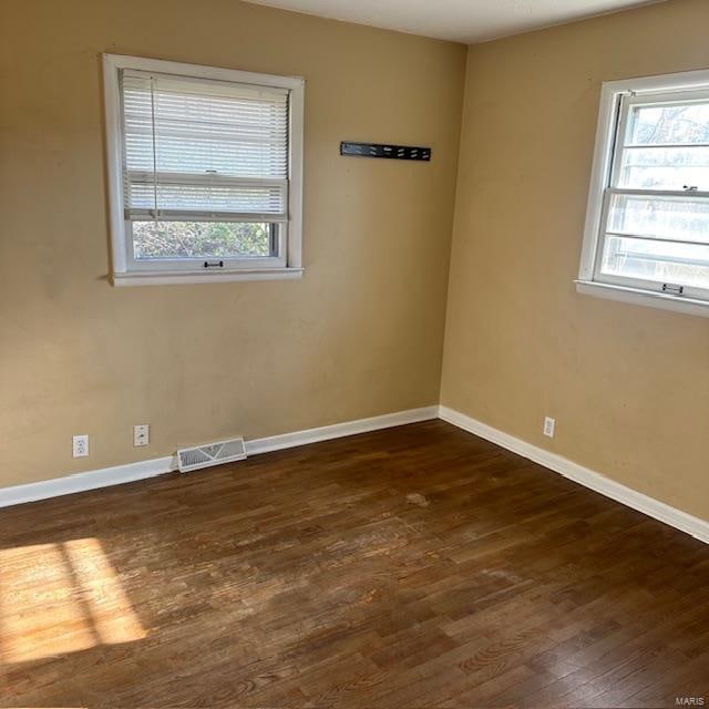 unfurnished room featuring dark wood-type flooring