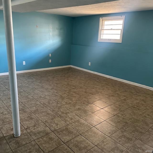 unfurnished room with a textured ceiling