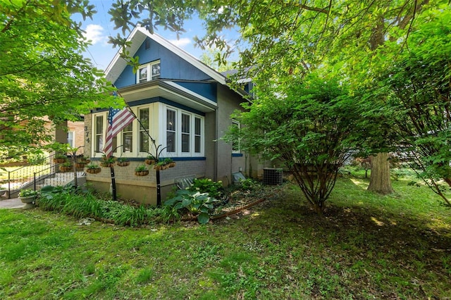 view of home's exterior with a yard and central air condition unit