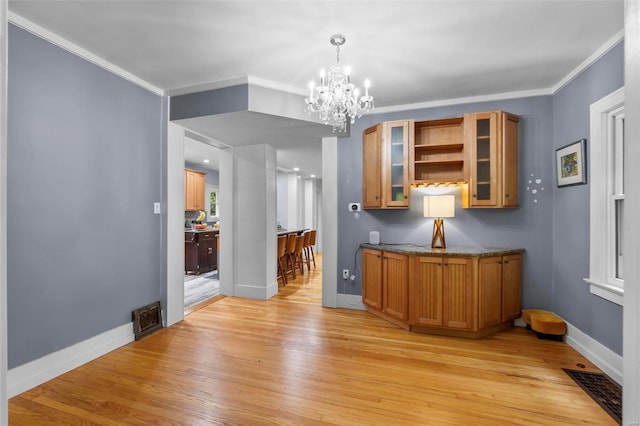 interior space with ornamental molding, light hardwood / wood-style floors, and a chandelier