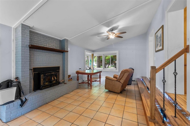 tiled living room featuring brick wall, a brick fireplace, ceiling fan, and lofted ceiling