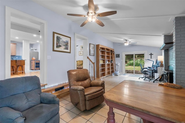 living room featuring ceiling fan, lofted ceiling, brick wall, and light tile floors