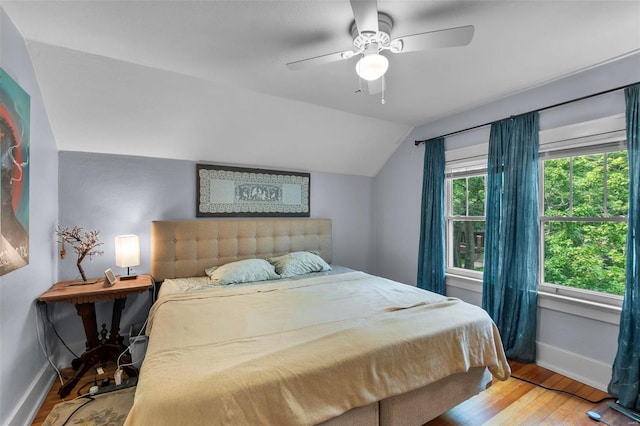 bedroom featuring vaulted ceiling, ceiling fan, and hardwood / wood-style flooring