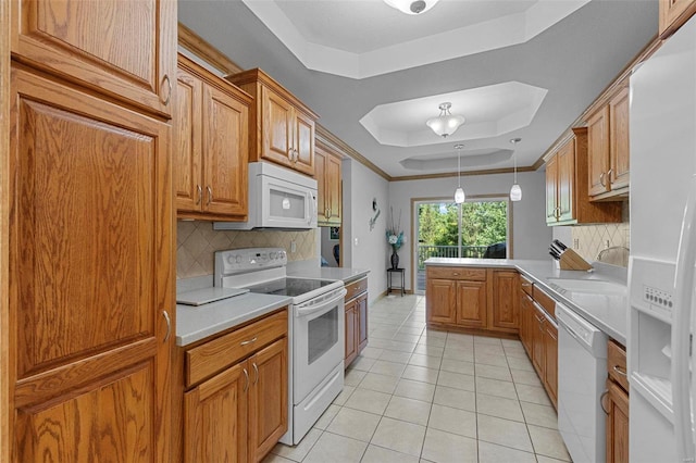 kitchen featuring tasteful backsplash, white appliances, a tray ceiling, decorative light fixtures, and light tile patterned flooring