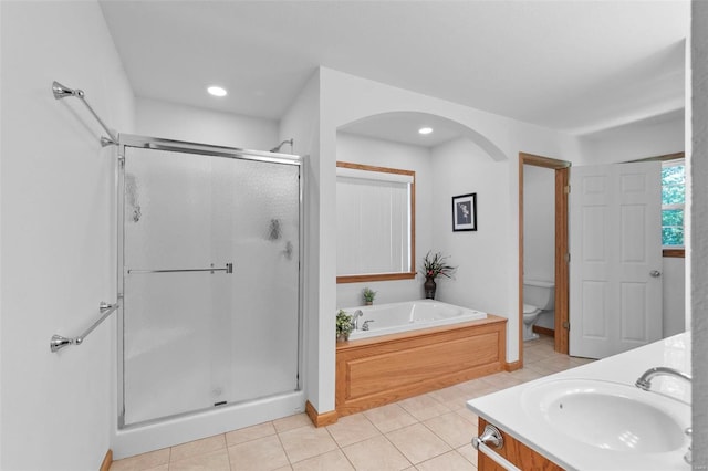 full bathroom with tile patterned flooring, vanity, separate shower and tub, and toilet