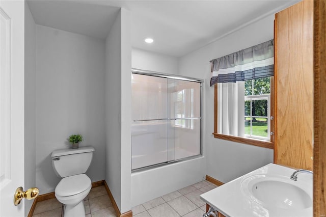 full bathroom with tile patterned floors, vanity, enclosed tub / shower combo, and toilet