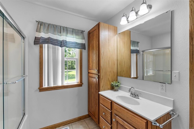 bathroom featuring tile patterned flooring, vanity, and an enclosed shower