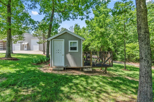 view of outbuilding featuring a lawn and a garage