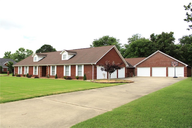 view of front of home with a front yard, an outdoor structure, and a garage