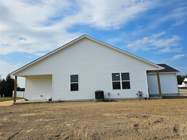 rear view of house featuring central AC