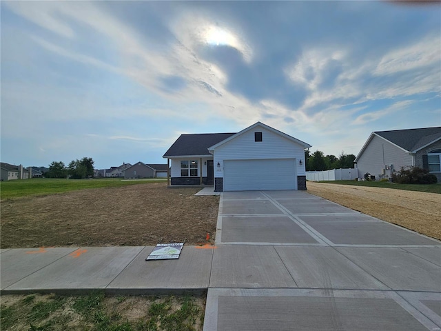 view of front of home featuring a garage and a front lawn