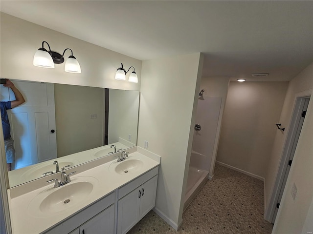 bathroom with walk in shower and vanity