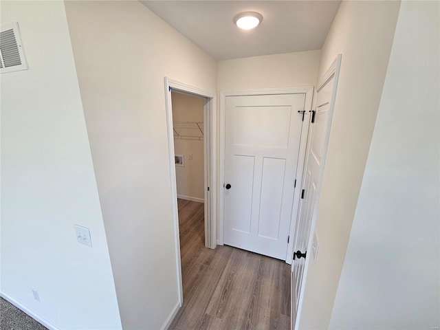 corridor with light hardwood / wood-style floors