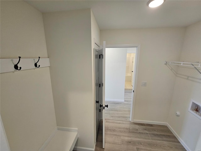 laundry room featuring washer hookup and light hardwood / wood-style floors