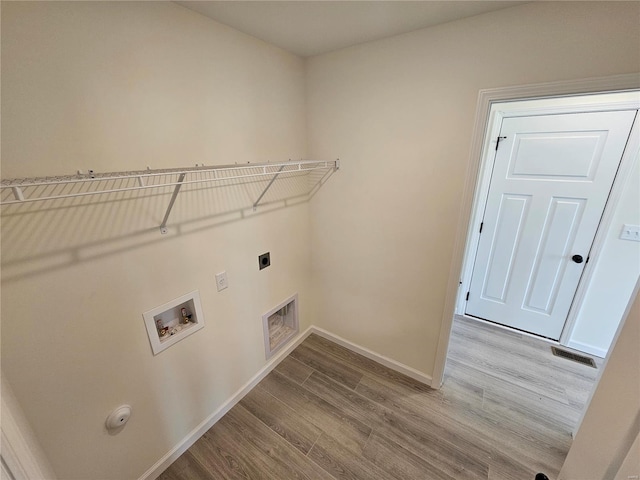 washroom with washer hookup, hookup for a gas dryer, electric dryer hookup, and light hardwood / wood-style floors