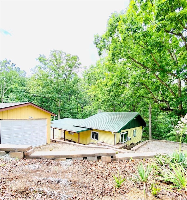 view of front of property featuring a garage and an outbuilding