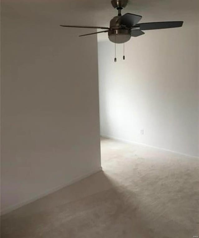 unfurnished room with ceiling fan and carpet flooring