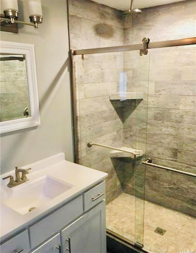 bathroom featuring an enclosed shower and vanity