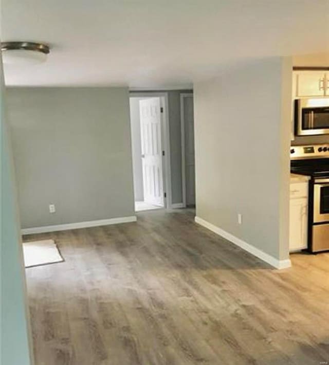 empty room with hardwood / wood-style flooring