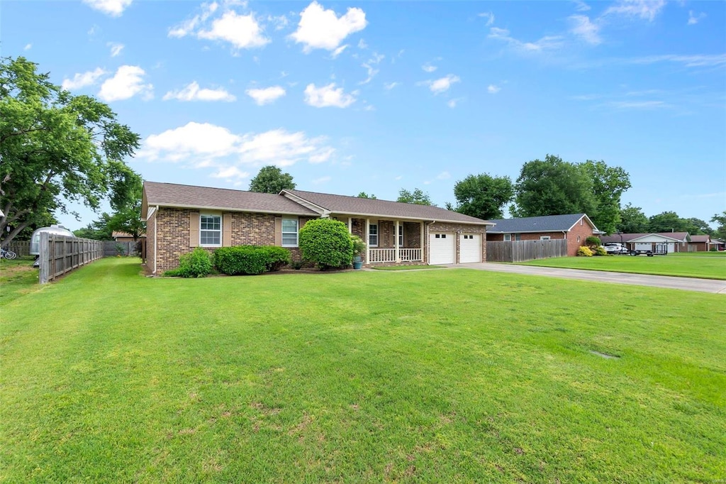 ranch-style house with a front yard and a garage