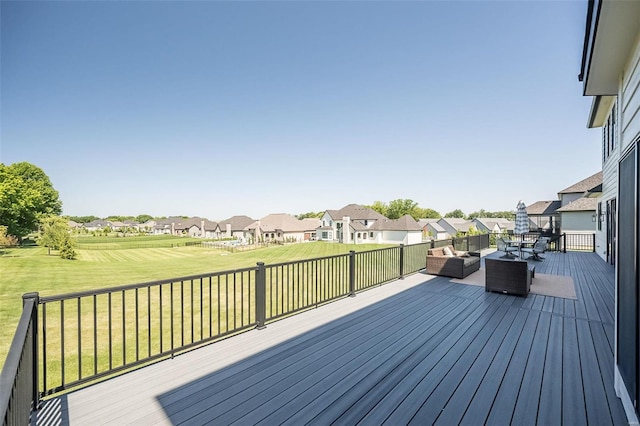 wooden terrace featuring an outdoor living space and a lawn