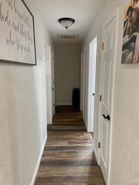 hallway featuring dark wood-type flooring