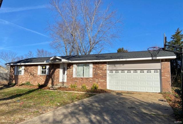 ranch-style home featuring an attached garage, concrete driveway, and brick siding