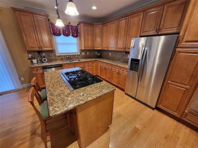 kitchen with stainless steel refrigerator with ice dispenser, black gas cooktop, hanging light fixtures, and light hardwood / wood-style flooring