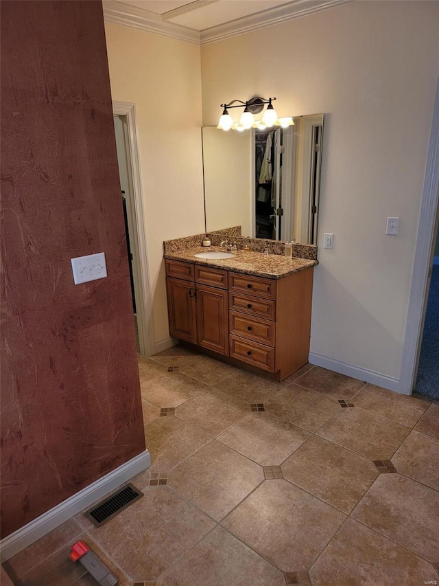 bathroom with tile floors, ornamental molding, and vanity