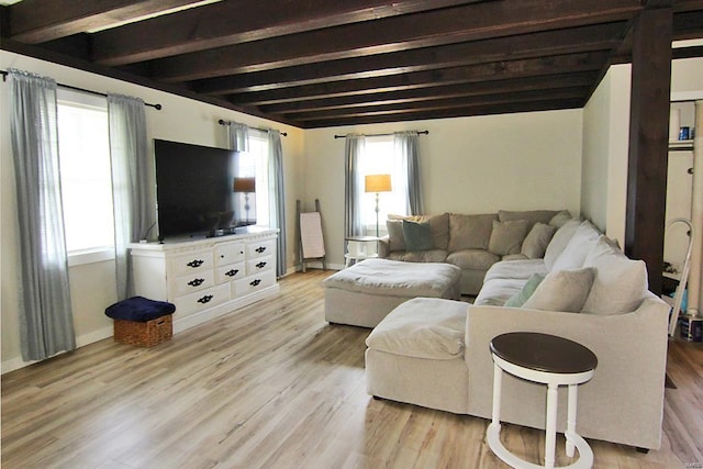 living room featuring beam ceiling and light hardwood / wood-style floors